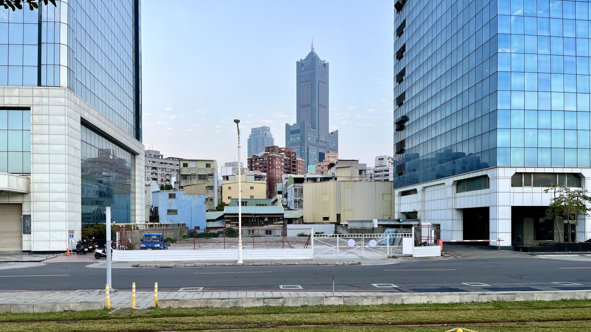 85 Sky Tower in the distance, framed by two glass skyscrapers.