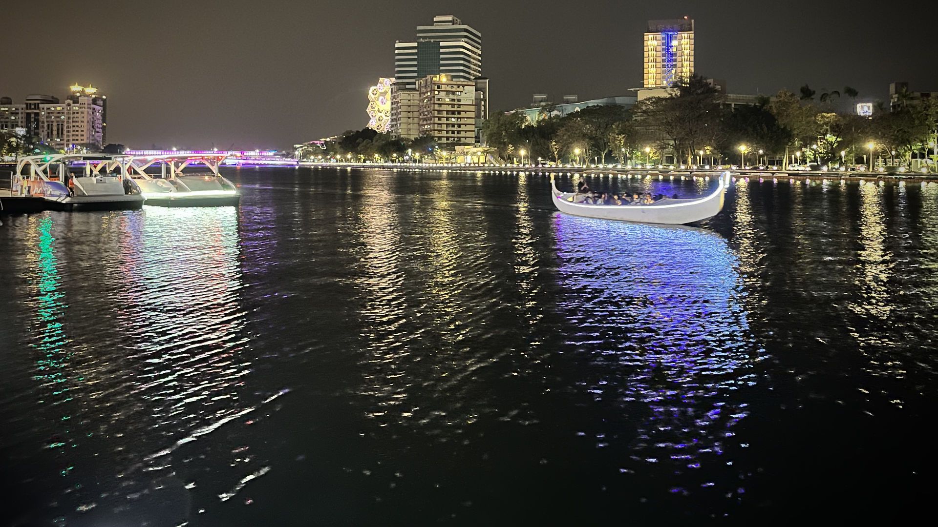 Tourists in a large electric gondola on love river.