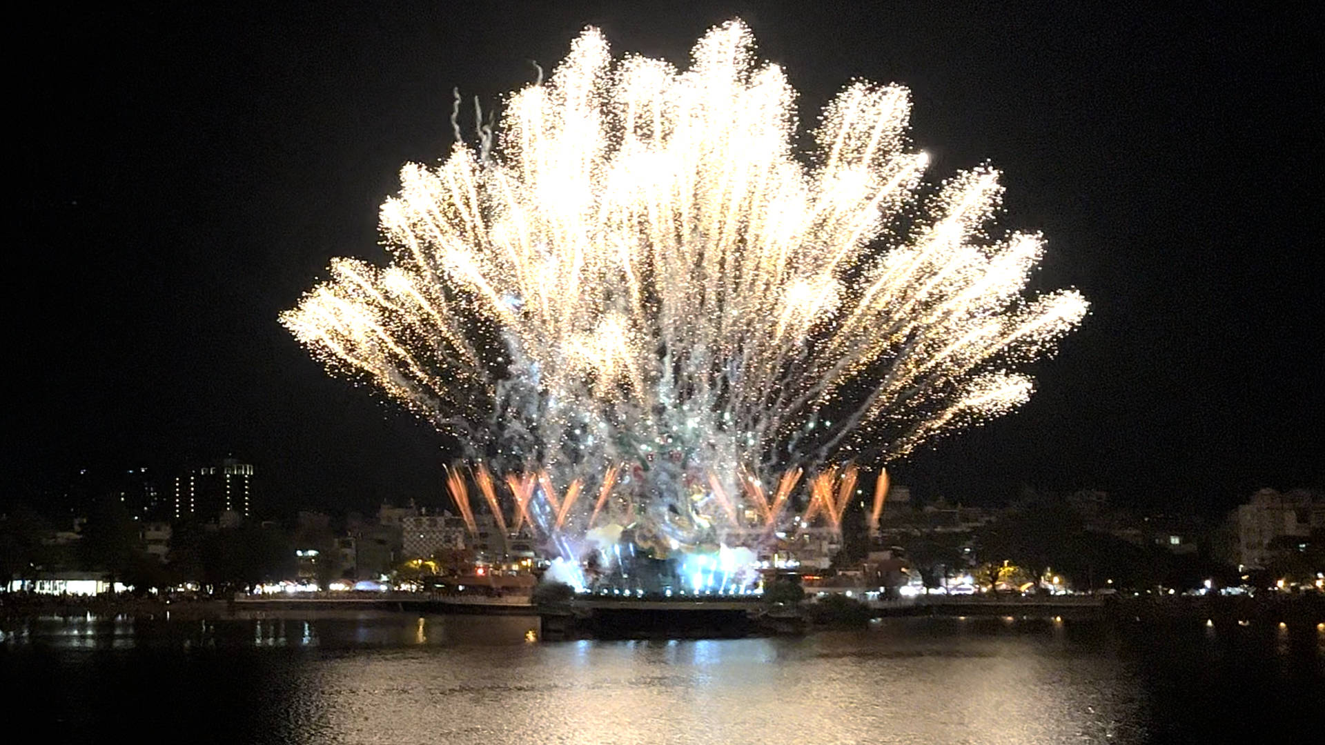 Impressive fireworks display launched from behind the 72-meter-tall Xuanwu statue, across Lotus Pond.