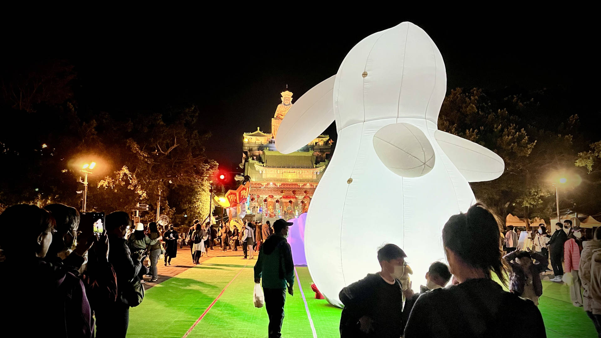 A large inflatable rabbit outside a temple.