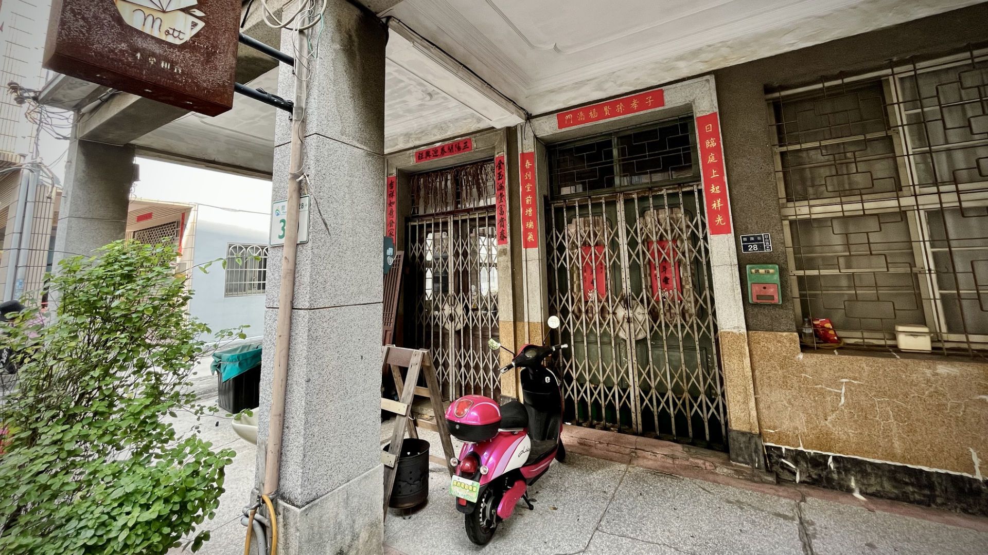 The exterior of Mottainai Cafe, on the ground floor of a historic urban building.