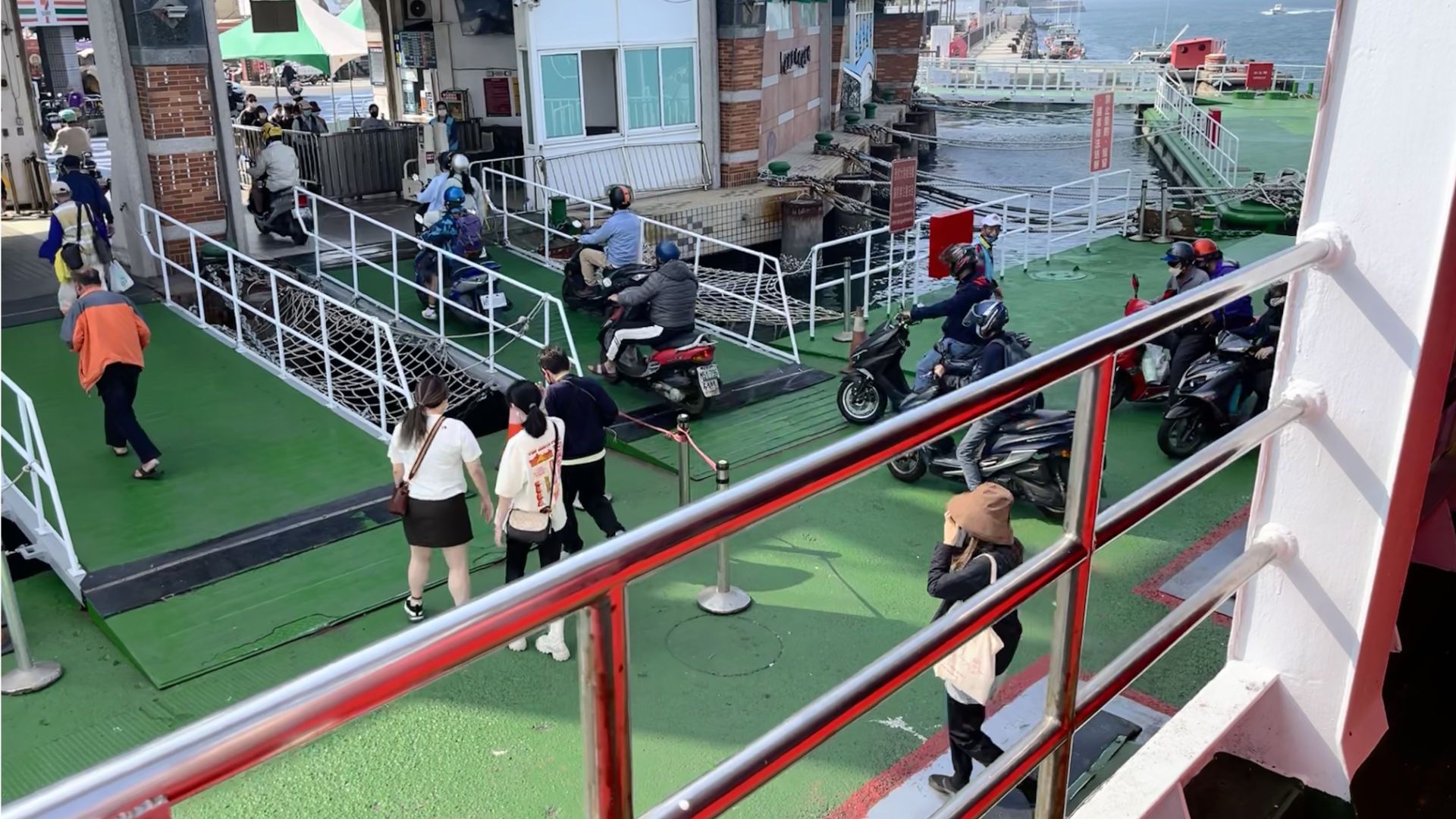 Scooters being driven off the Cijin Island ferry.
