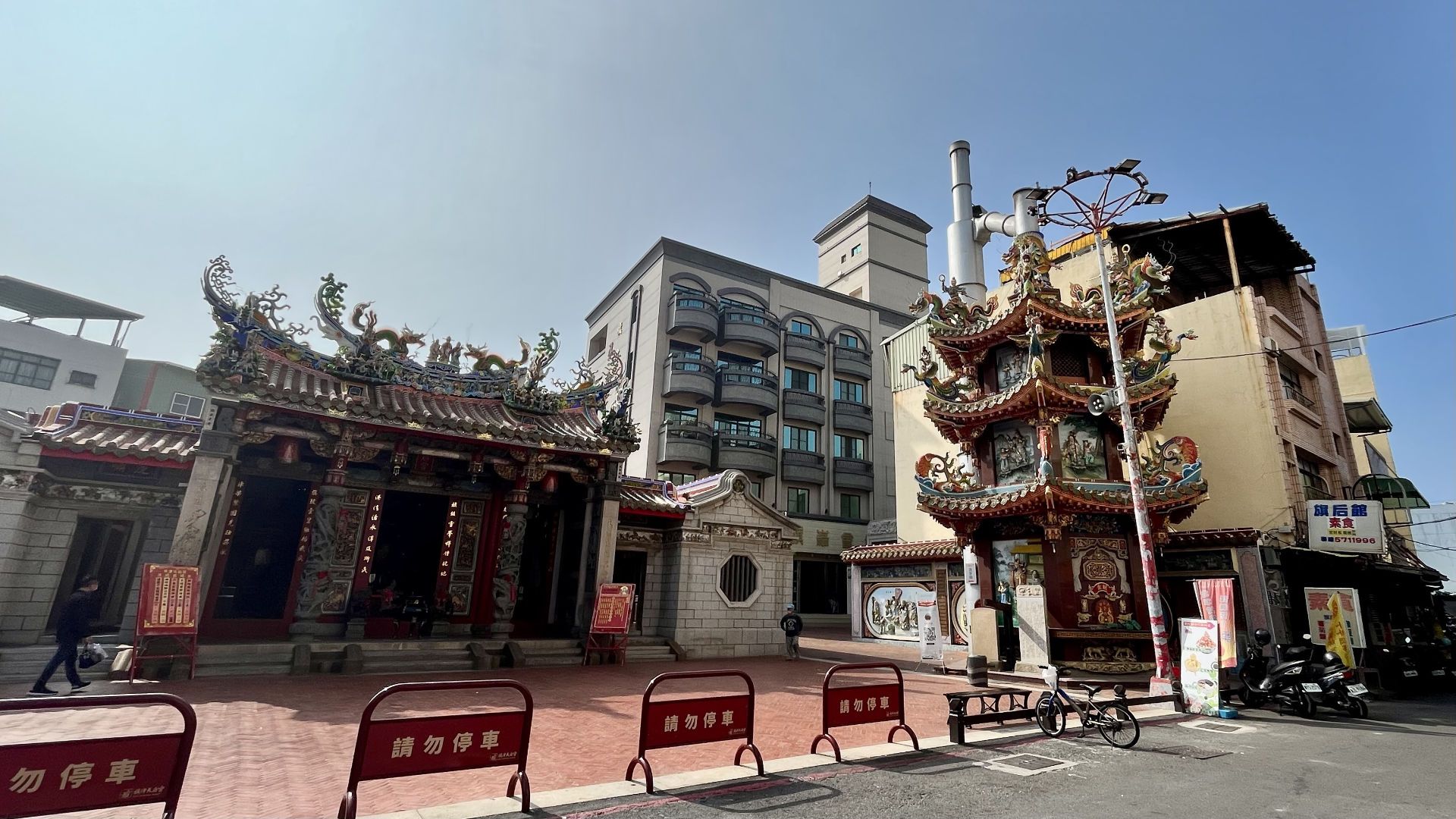 A small temple on the side of the street.