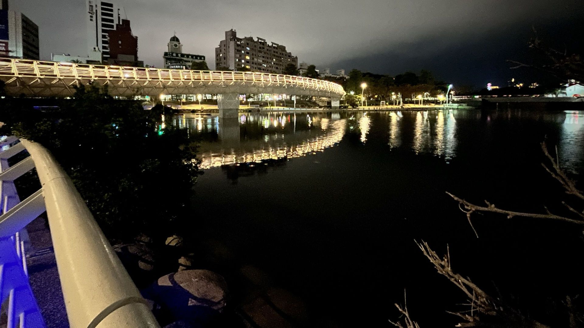 A wide-angle shot of the pedestrian bridge across the large lake at Heart of Love River.