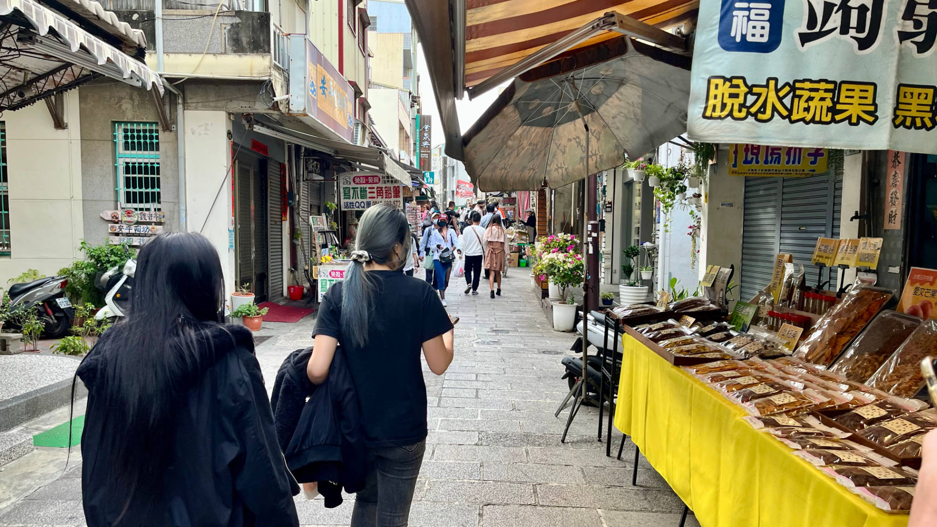 People walking along Anping Old Street in Tainan.