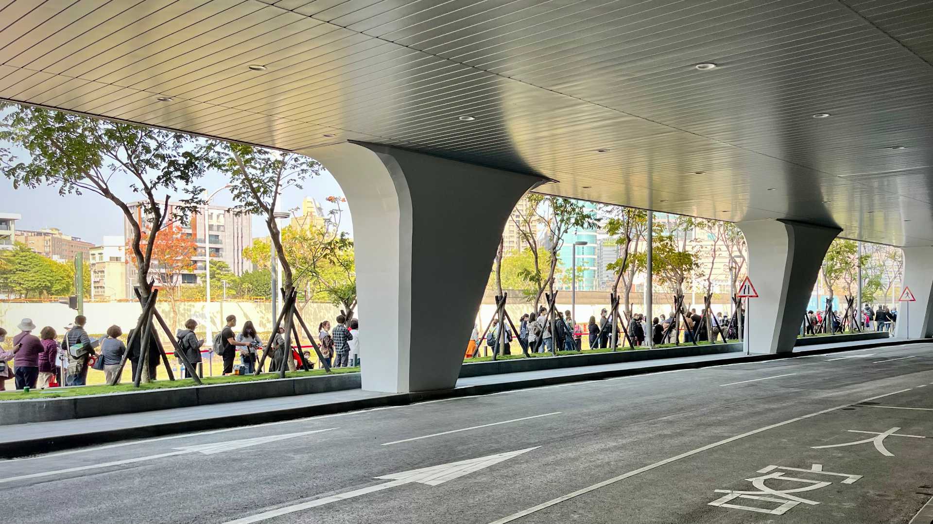 A queue of people standing outside the building.