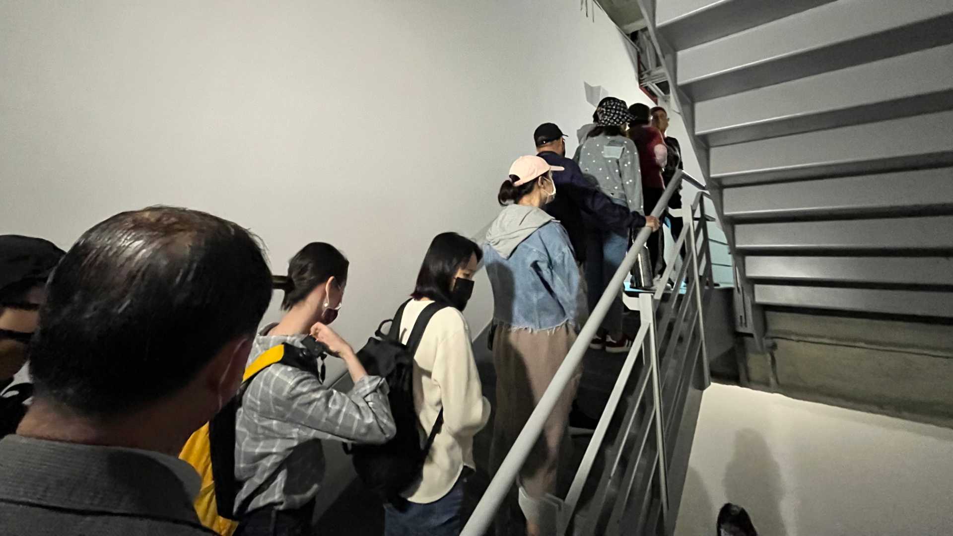 People queueing in the fire escape staircase.