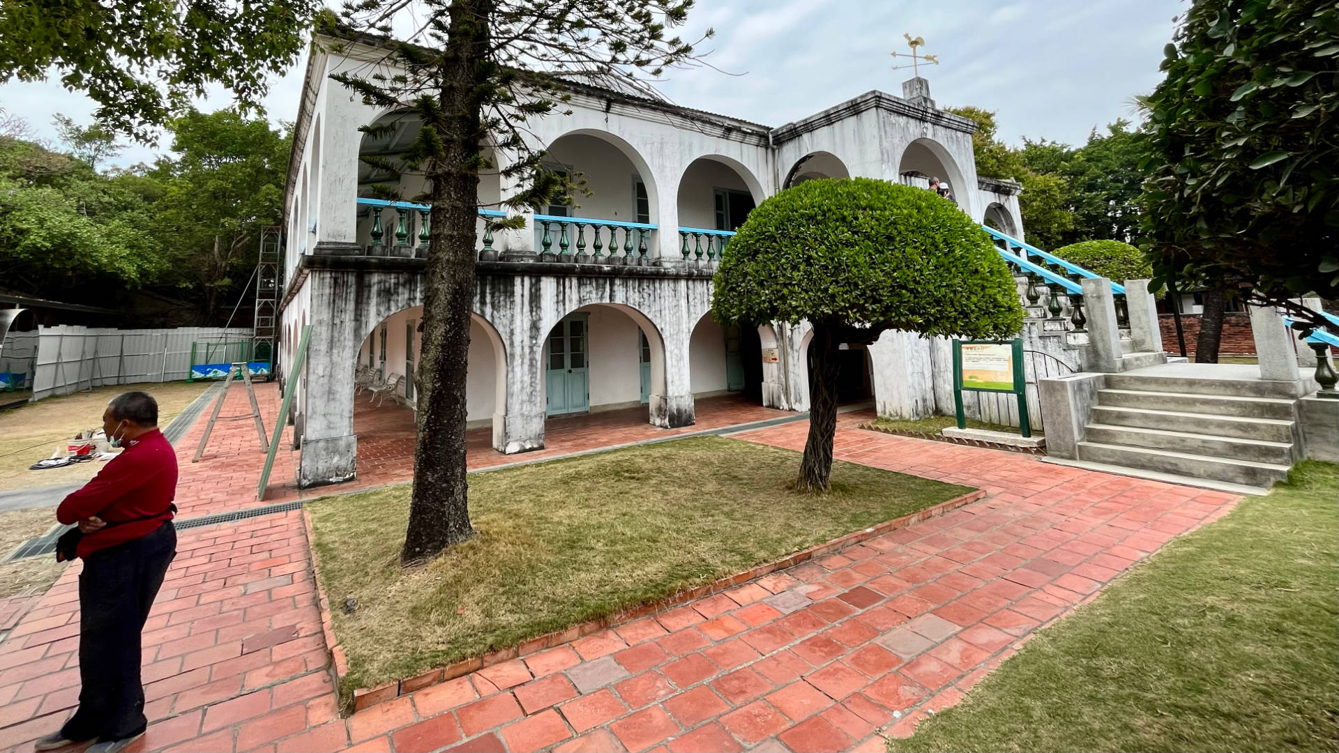 The Tait & Co. Merchant House, a whitewashed concrete mansion with wide arched verandahs on both levels.