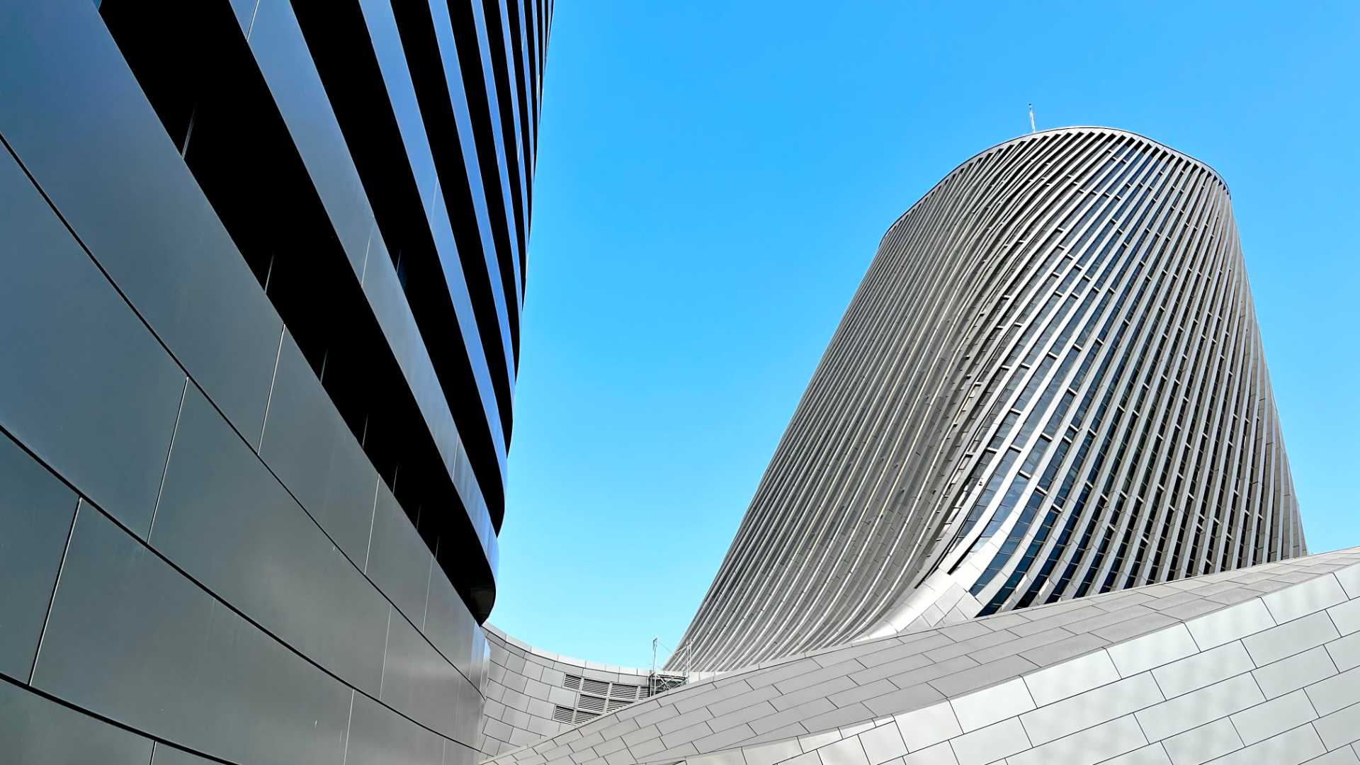 Abstract view of the curved metal and glass tower section of Kaohsiung Port Cruise Terminal.
