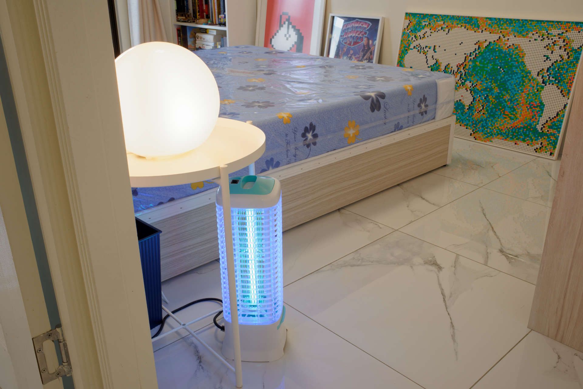 A UV lamp under a side-table in a bedroom.