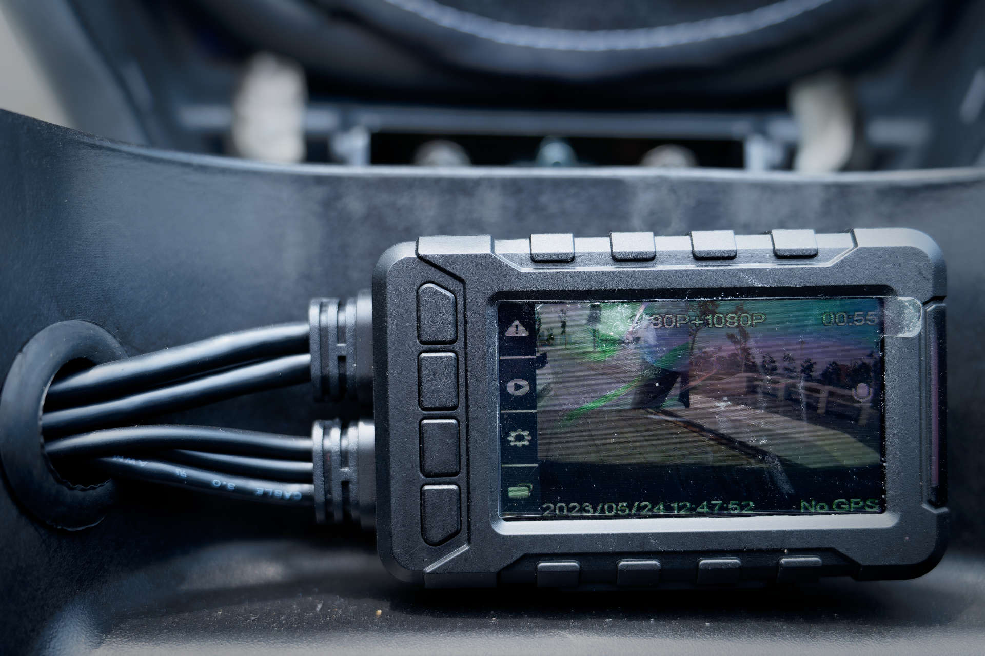 A Polaroid MS276WG FHD Motorcycle Recording Camera (Night Vision) head unit mounted in the under-seat storage of an SYM MMBCU scooter.