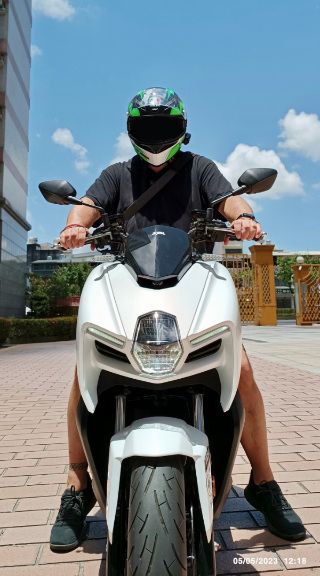 Man riding an SYM MMBCU scooter.