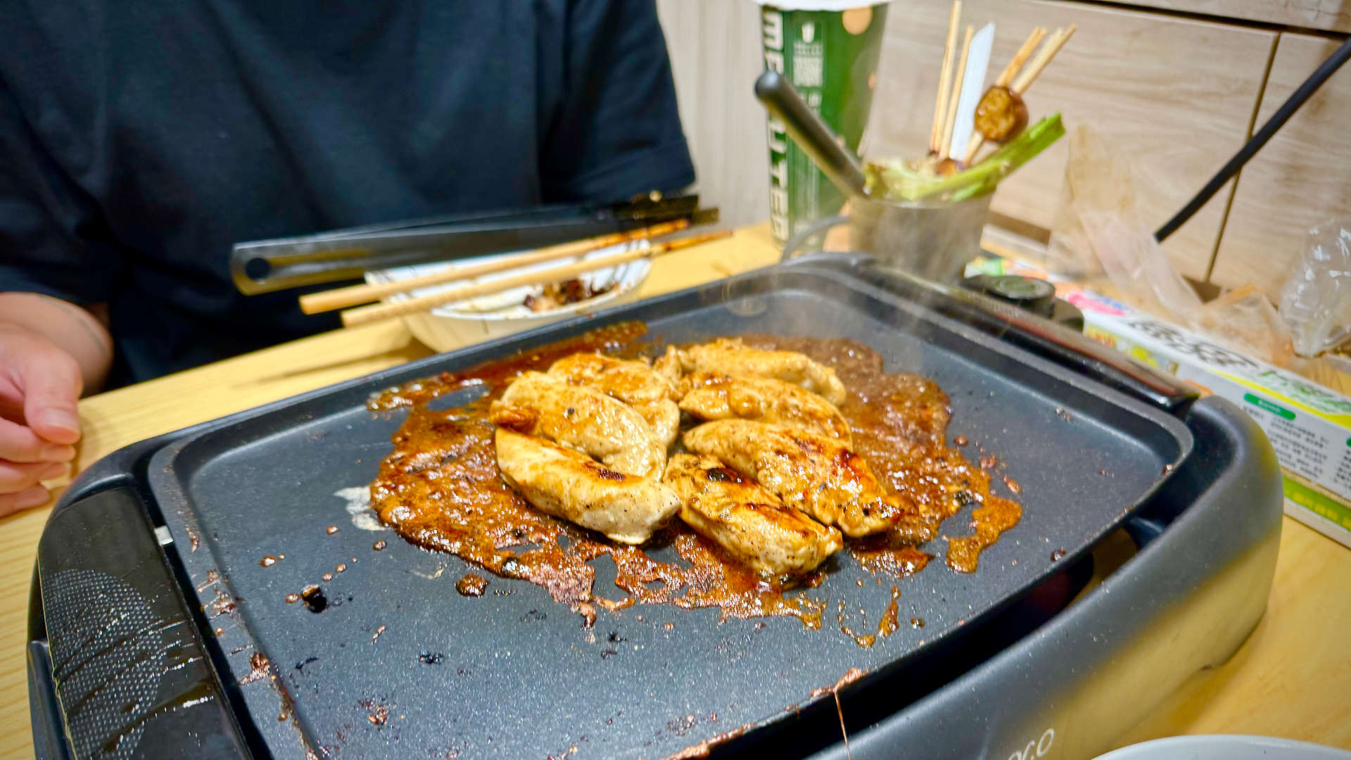 Chicken cooking on an indoor barbeque grill.