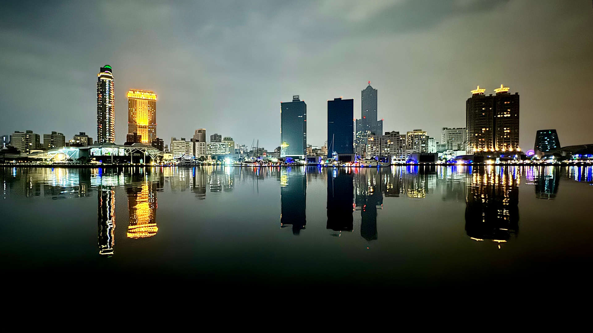 Nighttime view of Kaohsiung skyscrapers from across the harbor.