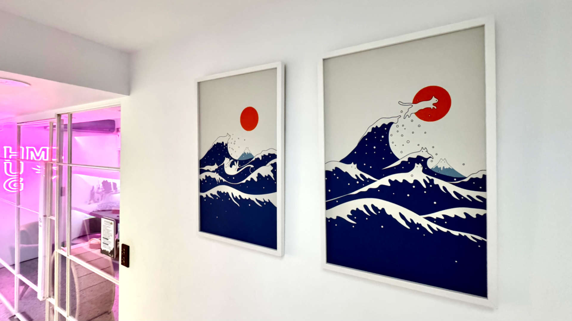 Two versions of the famous ‘Great Wave off Kanagawa’ print. In each version, the waves look like white cats.