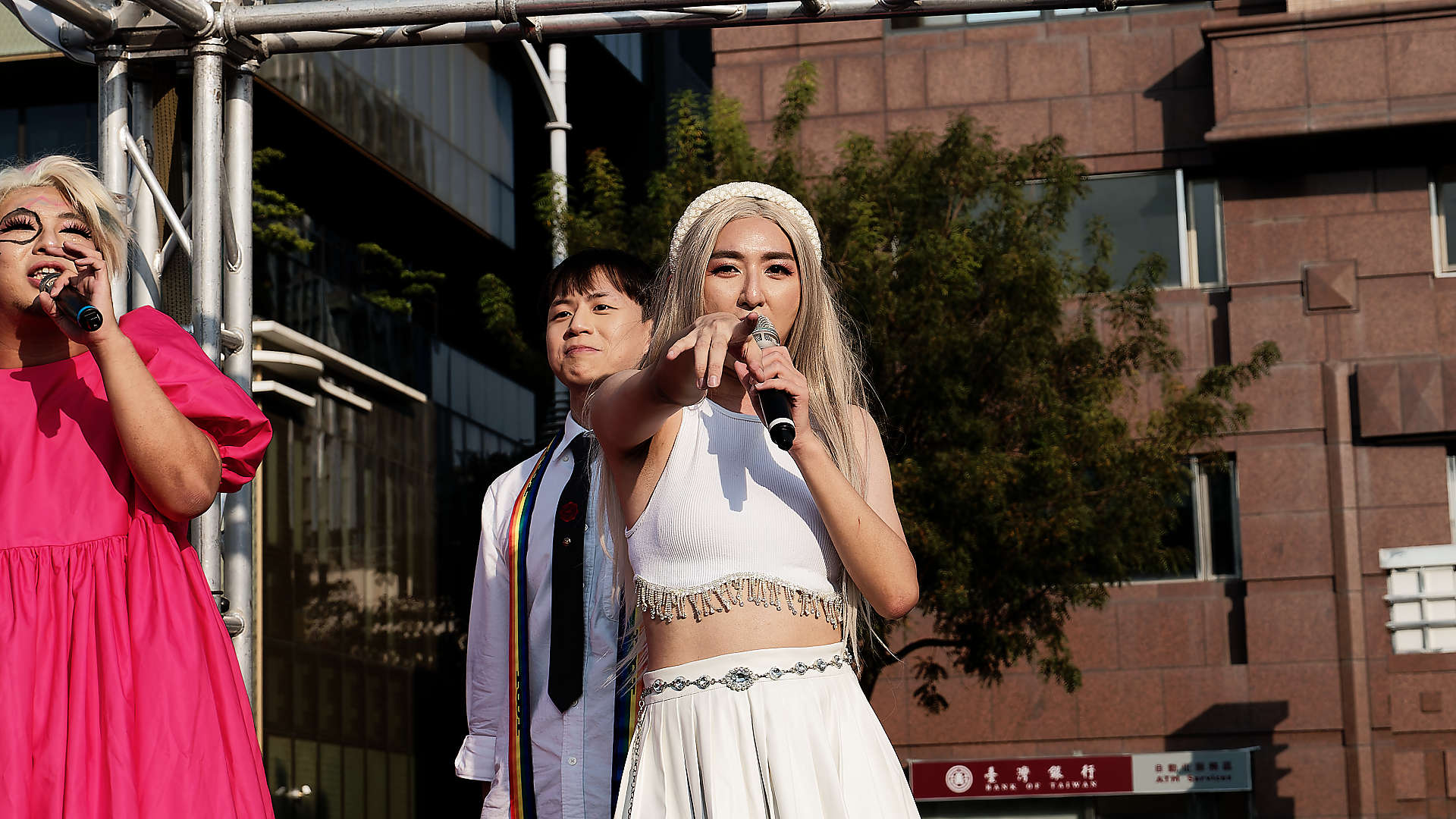 Singer pointing at the camera, in the Kaohsiung Pride parade.