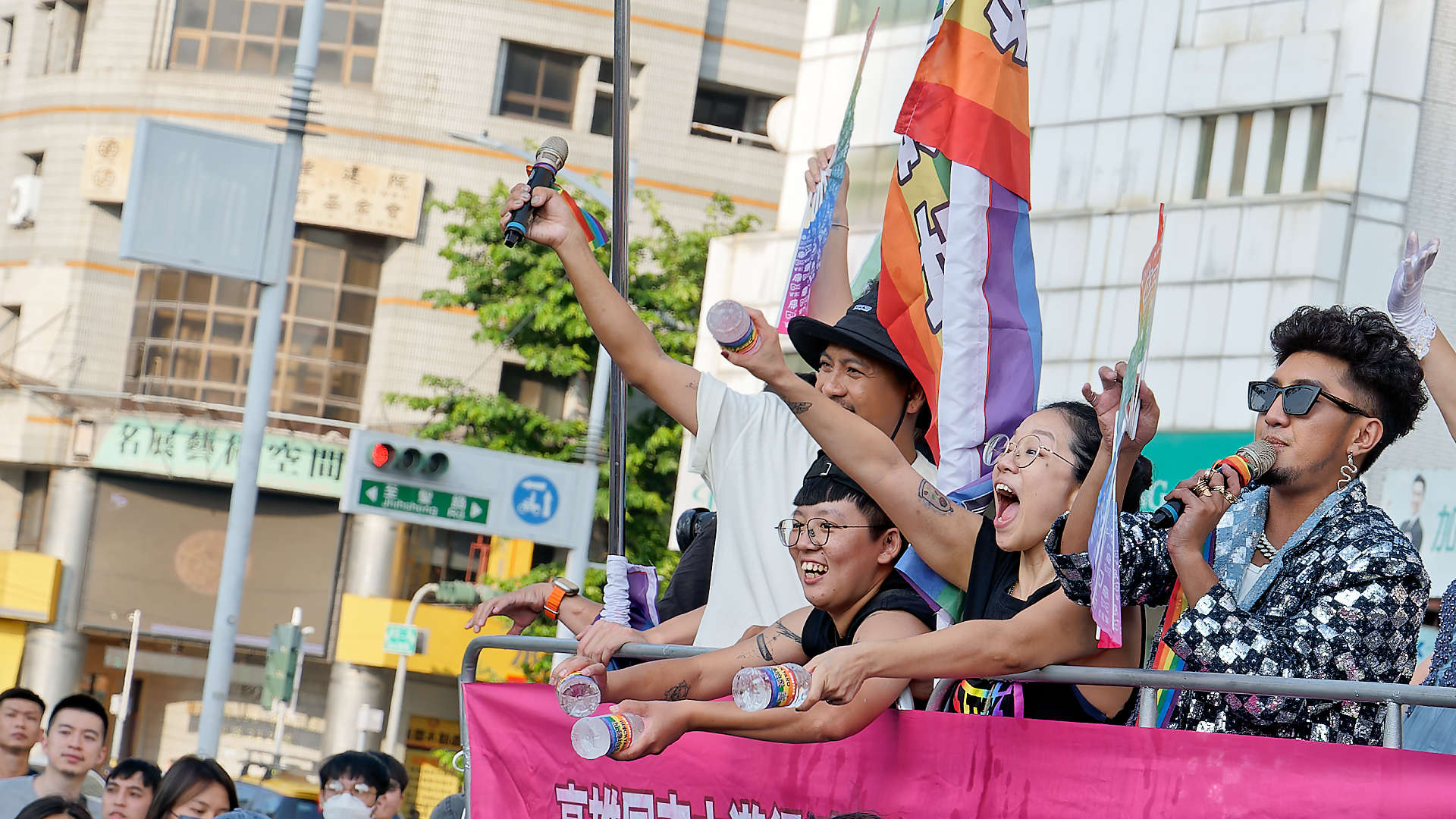 People calling out to the crowd from a float in the Kaohsiung Pride parade.
