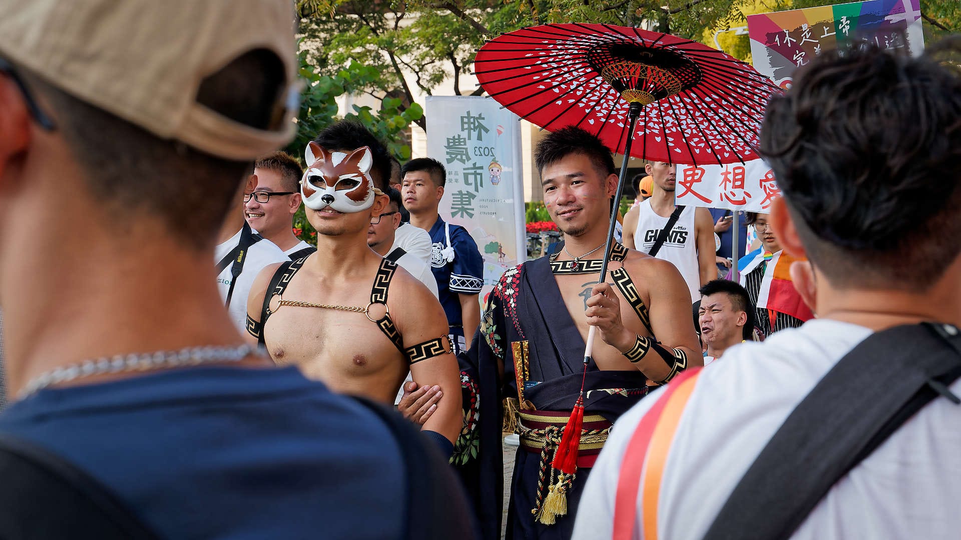 Two men in costume, walking arm-in-arm.