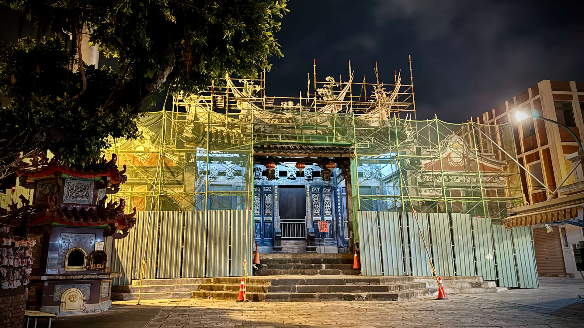 Penghu Tianhou Temple obscured by scaffolding at night.