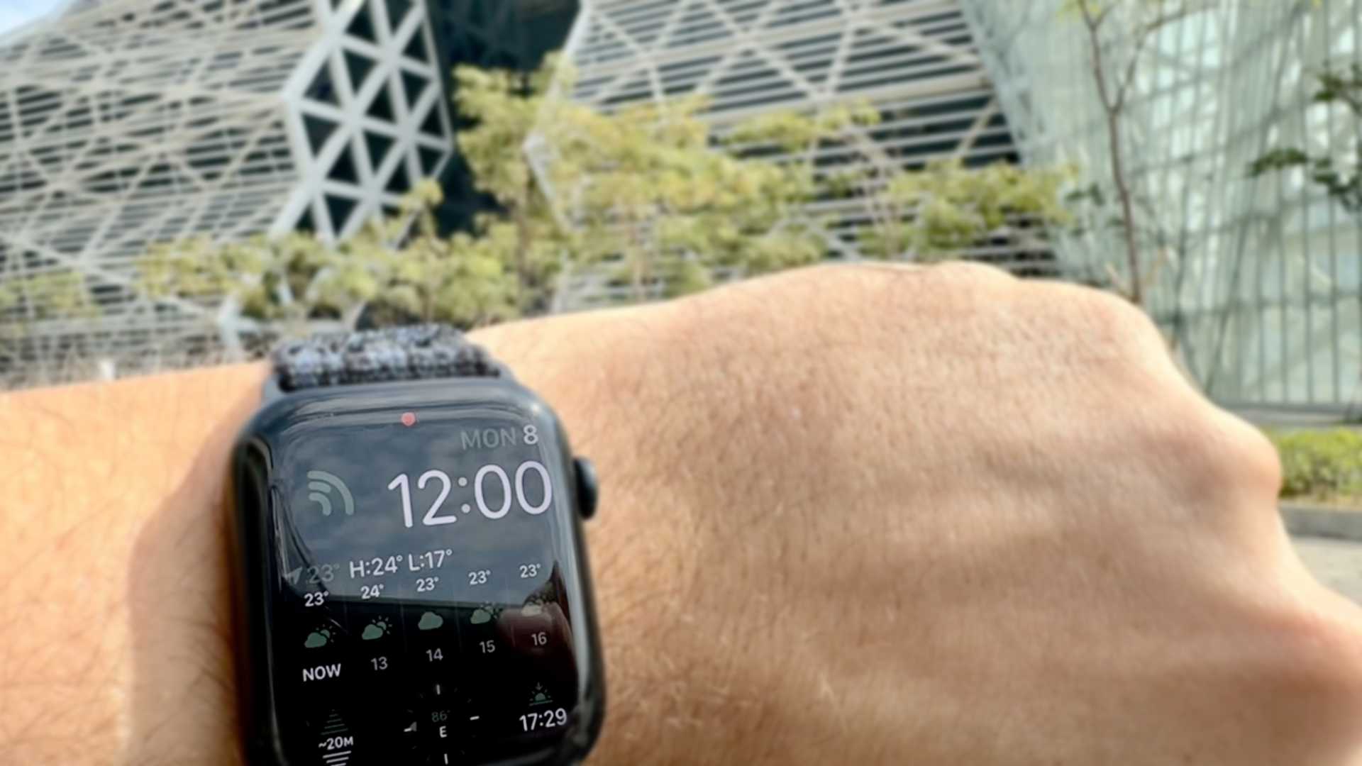 Close-up of an Apple Watch on a wrist. The time shows 12 o’clock on Monday the 8th. The weather complication shows it’s currently 23ºC.