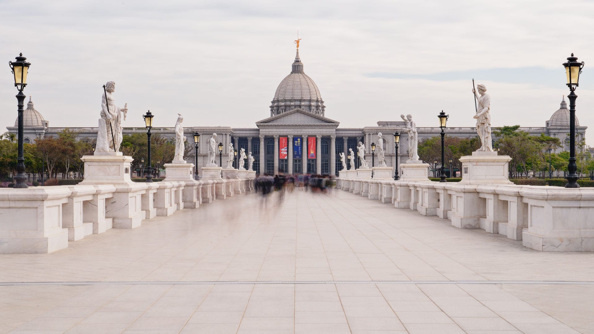 Long exposure of Olympic Bridge leading to Chimei Museum. The museum is built of stone in a neoclassical style, with a large dome topped by a golden statue.