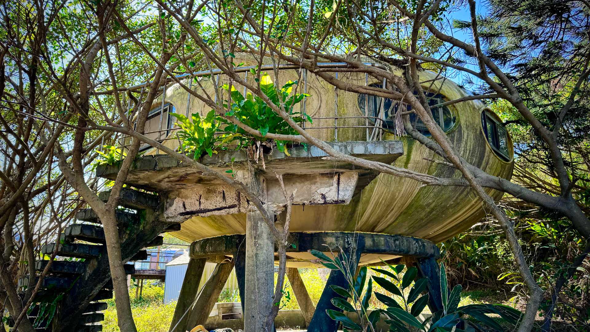 A Futuro house at Wanli UFO Village in Taiwan, elevated on concrete stilts.