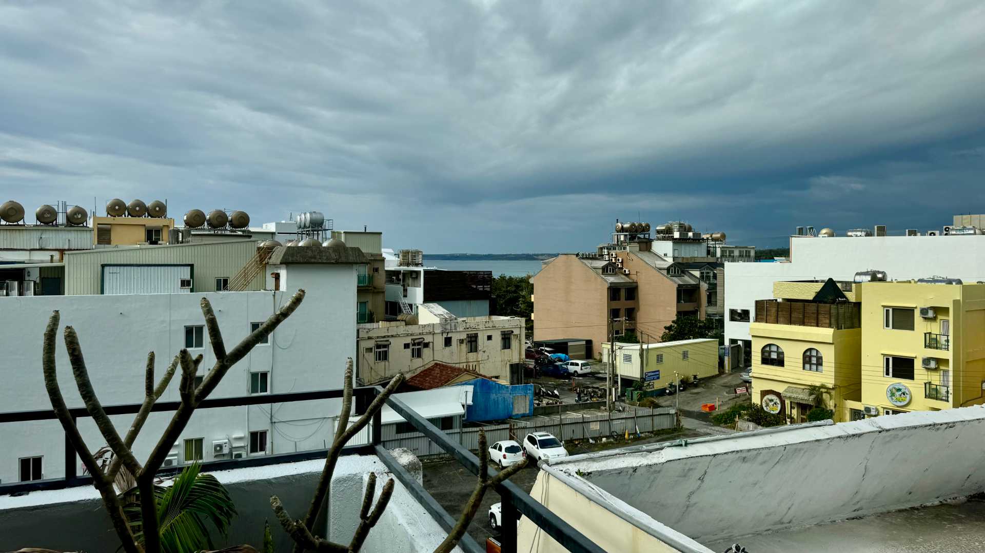 Looking over the rooftops of Kenting Township. The bay is visible in the distance. The sky is coudy.