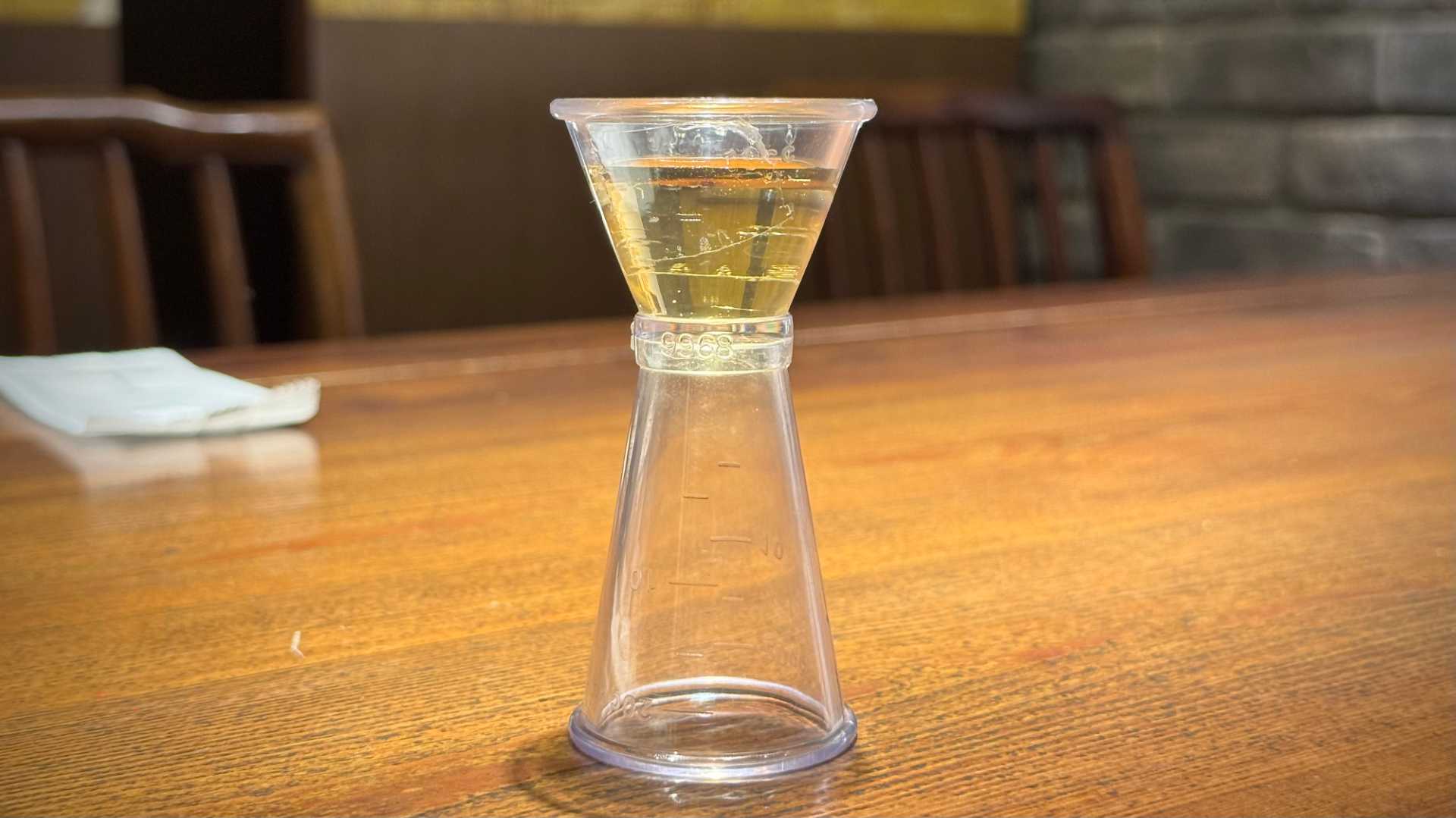 Golden liquid can sugar in a measuring container.