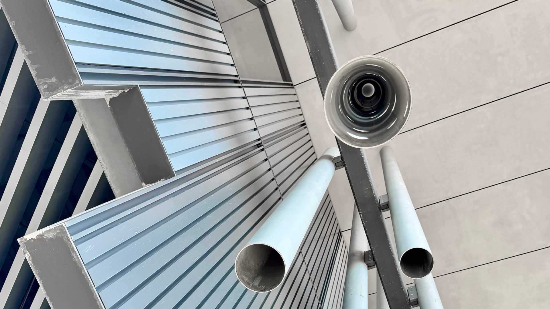 Close-up of some of the vertical round metal pipes used to enhance the exterior of the New Taipei City Art Museum.