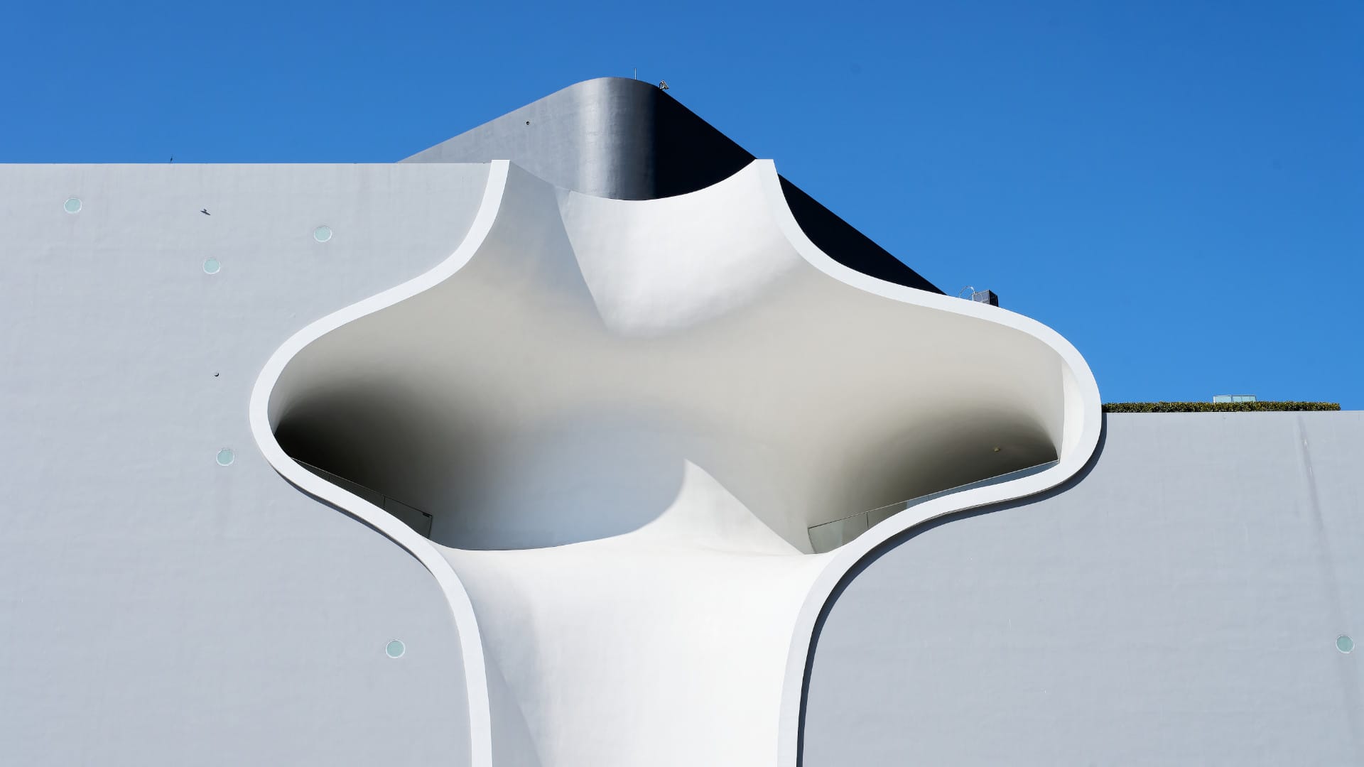 Closer-up of one of the concave external balcony spaces of the National Taichung Theater. The spaces almost look like caves hollowed from the face of the building.