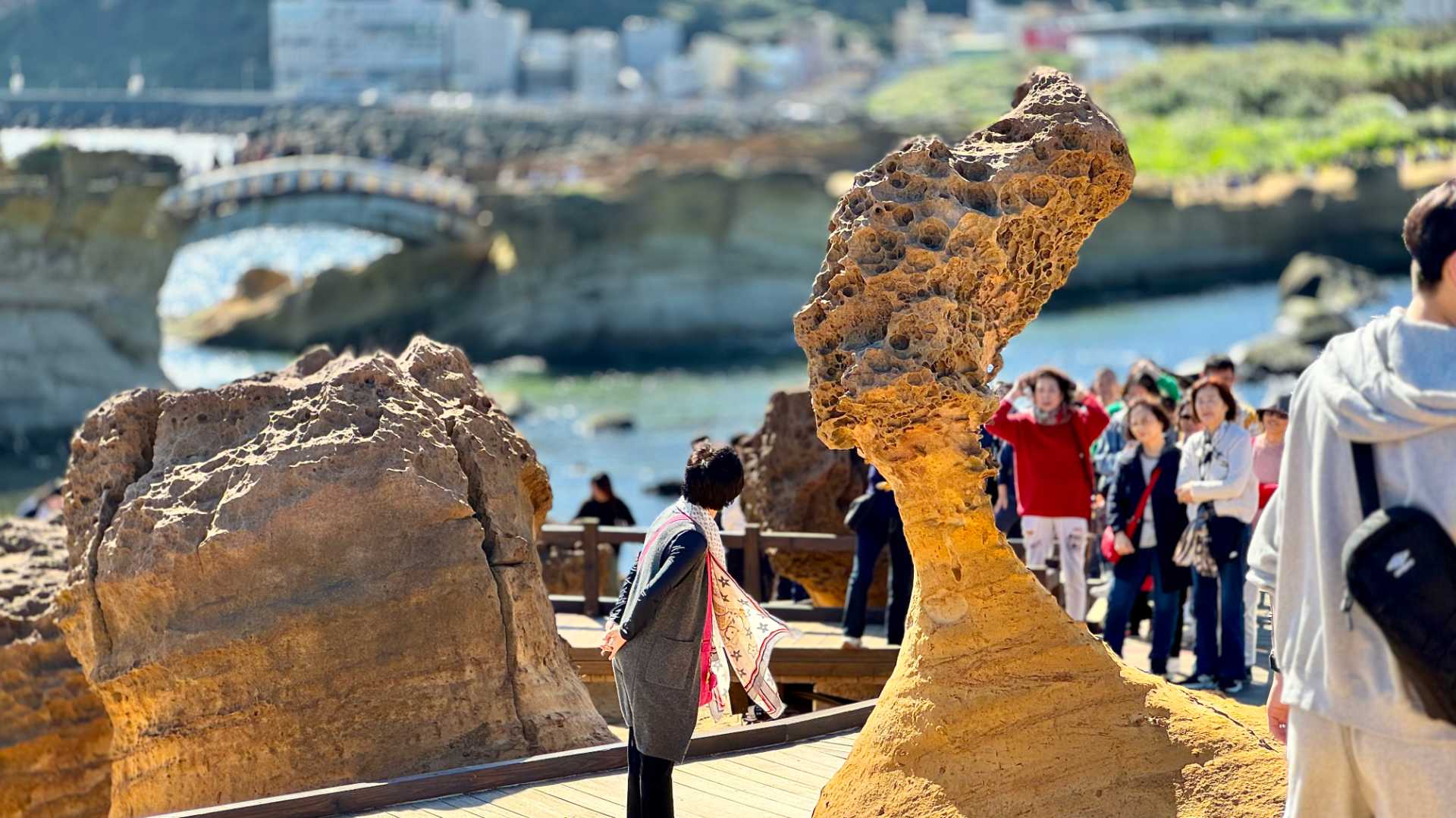 The Queen’s Head Rock in New Taipei, Taiwan. It is a pourous rock that has been eroded by the wind to look like the side profile of Queen Elizabeth II. A dozen people are looking at it from the other side.