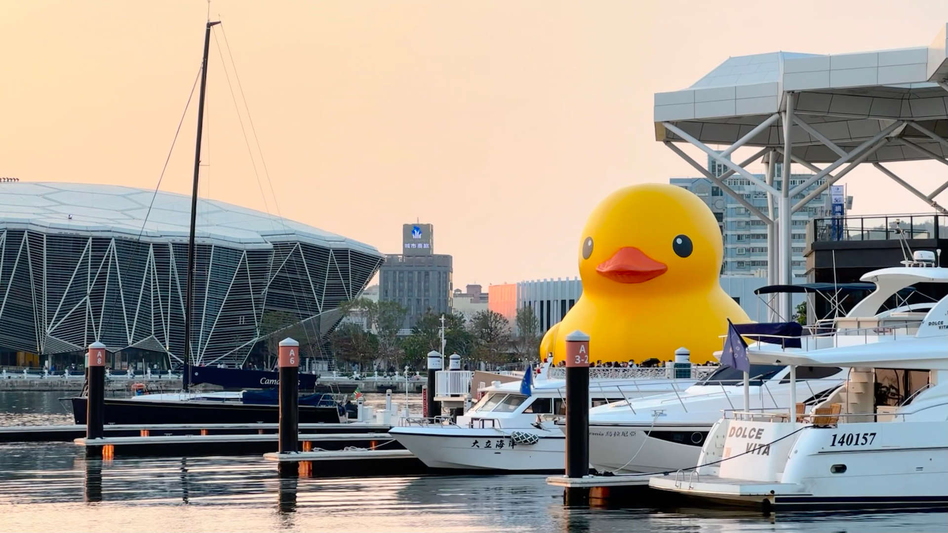 A large yellow duck floating on Kaohsiung Harbor just before sunset.