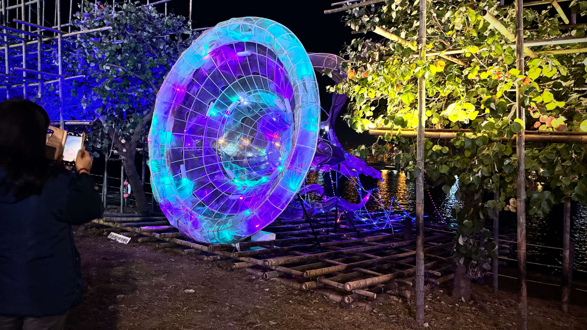 A jellyfish or horn-like lantern, perhaps two meters tall and a few meters long, projecting onto the land from Anping Harbor.