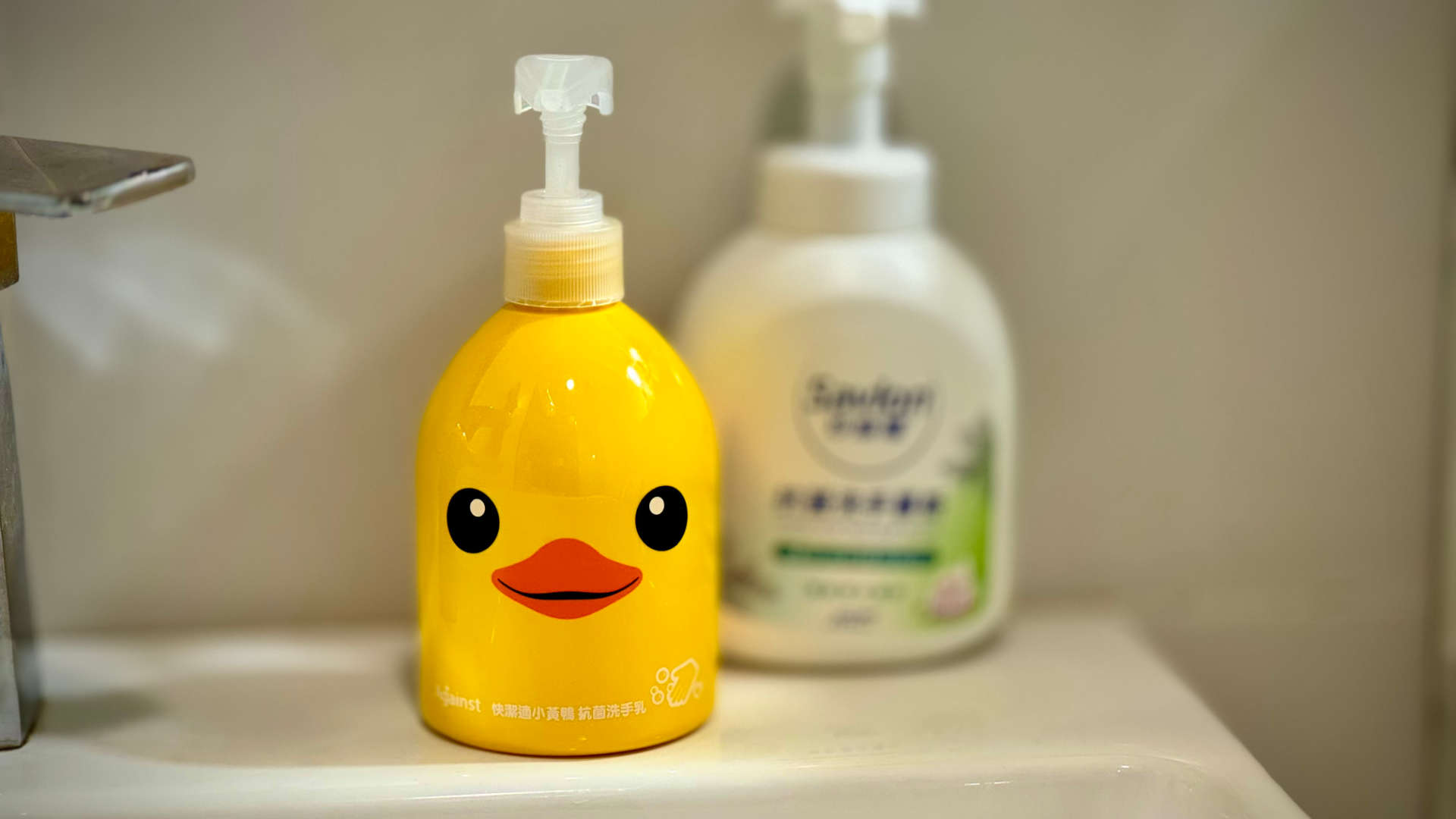 A yellow duck-shaped hand soap dispenser.