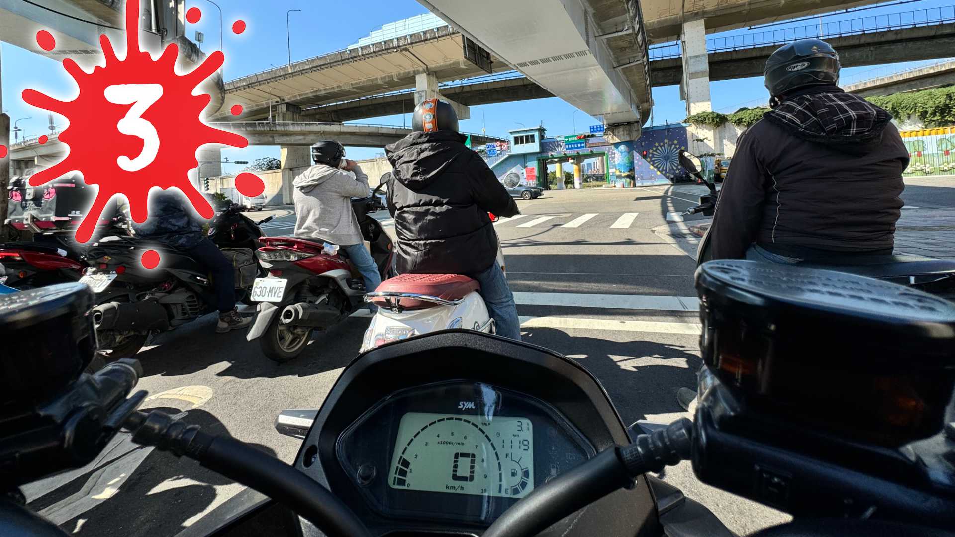 First-person point of view, riding a scooter in Taipei with other scooters in front and to the side. The number 3 is superimposed on top.