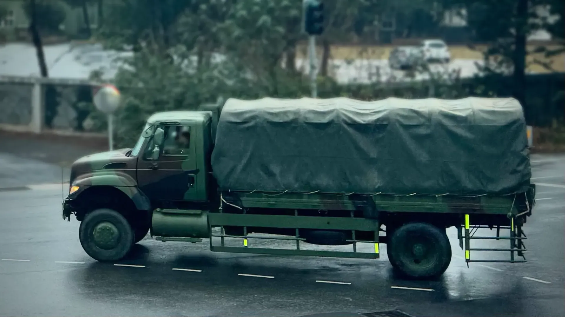 An army truck driving on a public road on Penghu Island.