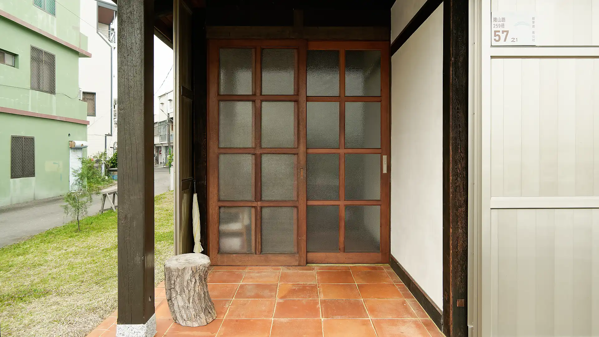 Exterior shot of the tiled, covered entranceway of ‘A Book Wooden House’.