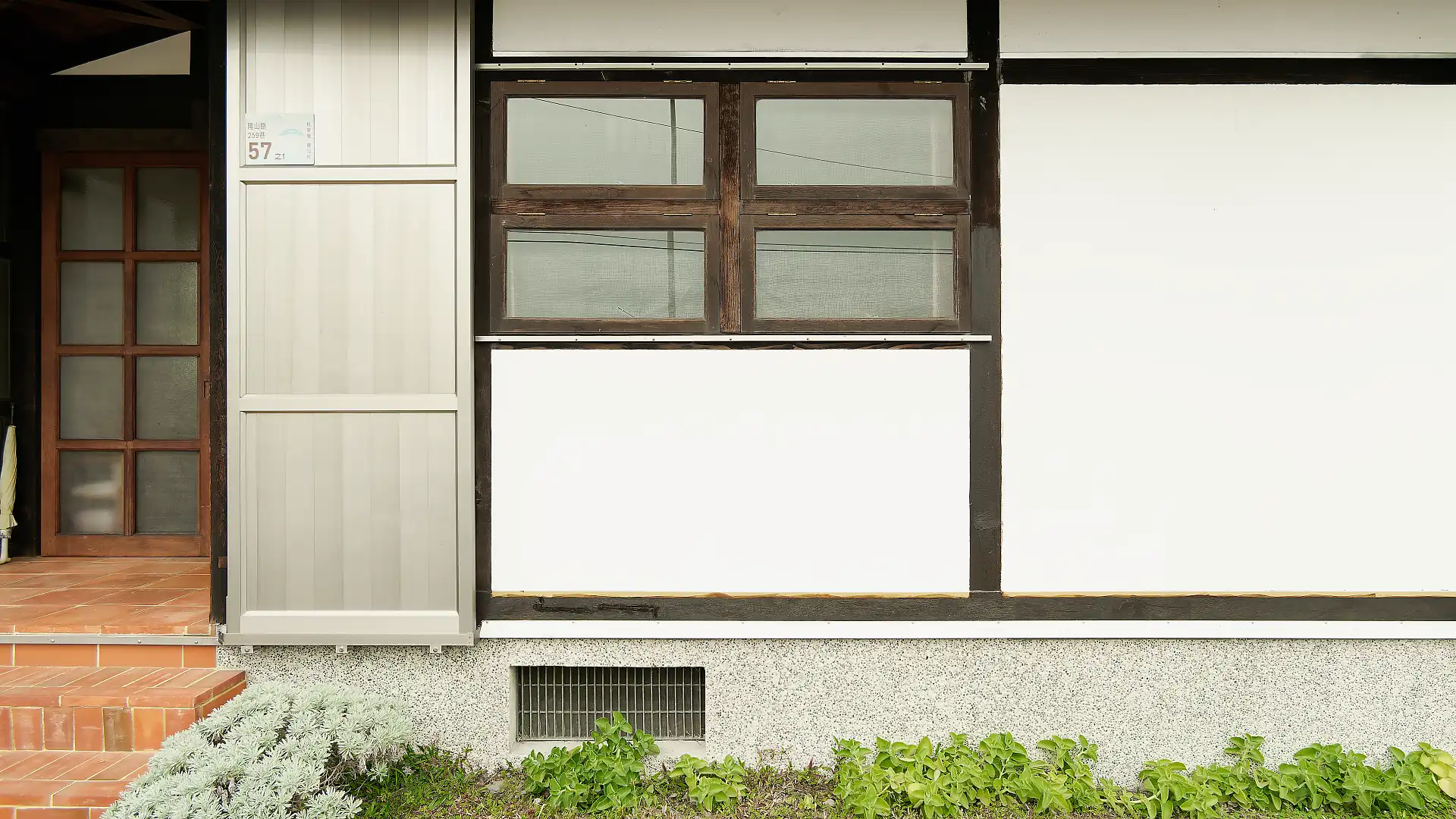 Exterior shot of the living room window of ‘A Book Wooden House’.