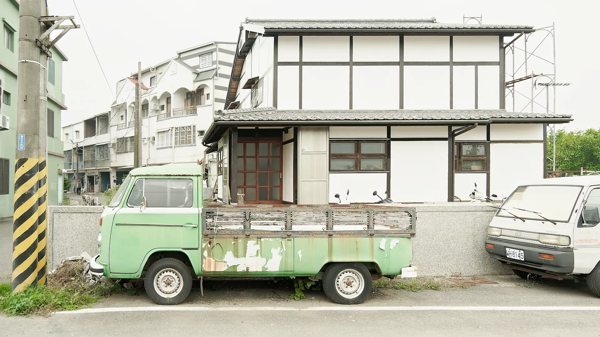 Street frontage of ‘A Book Wooden House’ in Fangliao Township, Pingtung, Taiwan. A vintage Volkswagen truck is parked on the street outside.
