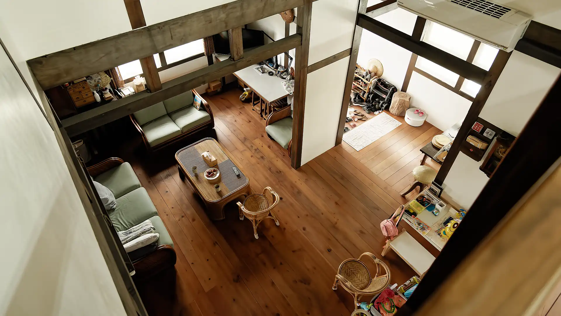 Looking down, from the second floor to the expansive living area on the first floor of ‘A Book Wooden House’.