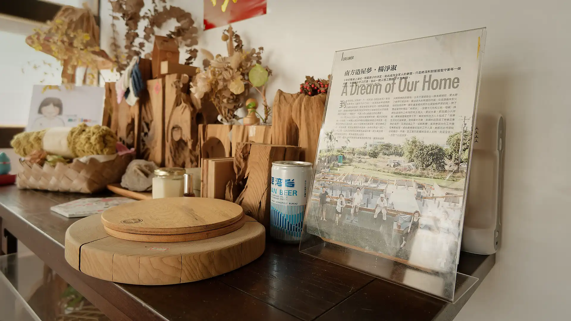 Close-up of a printed magazine article about ‘A Book Wooden House’, titled ‘A Dream of Our Home’.