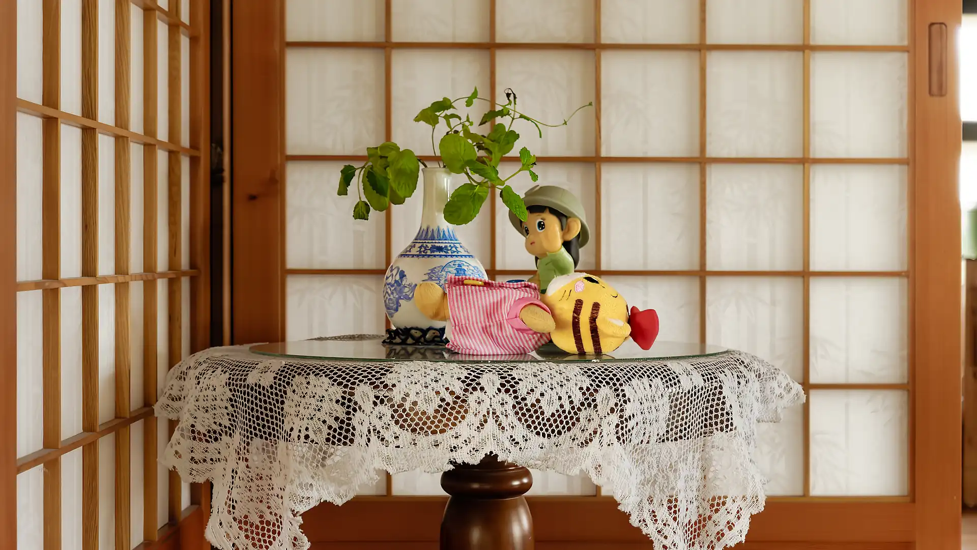 Close-up of a decorated side table in front of shoji screens.