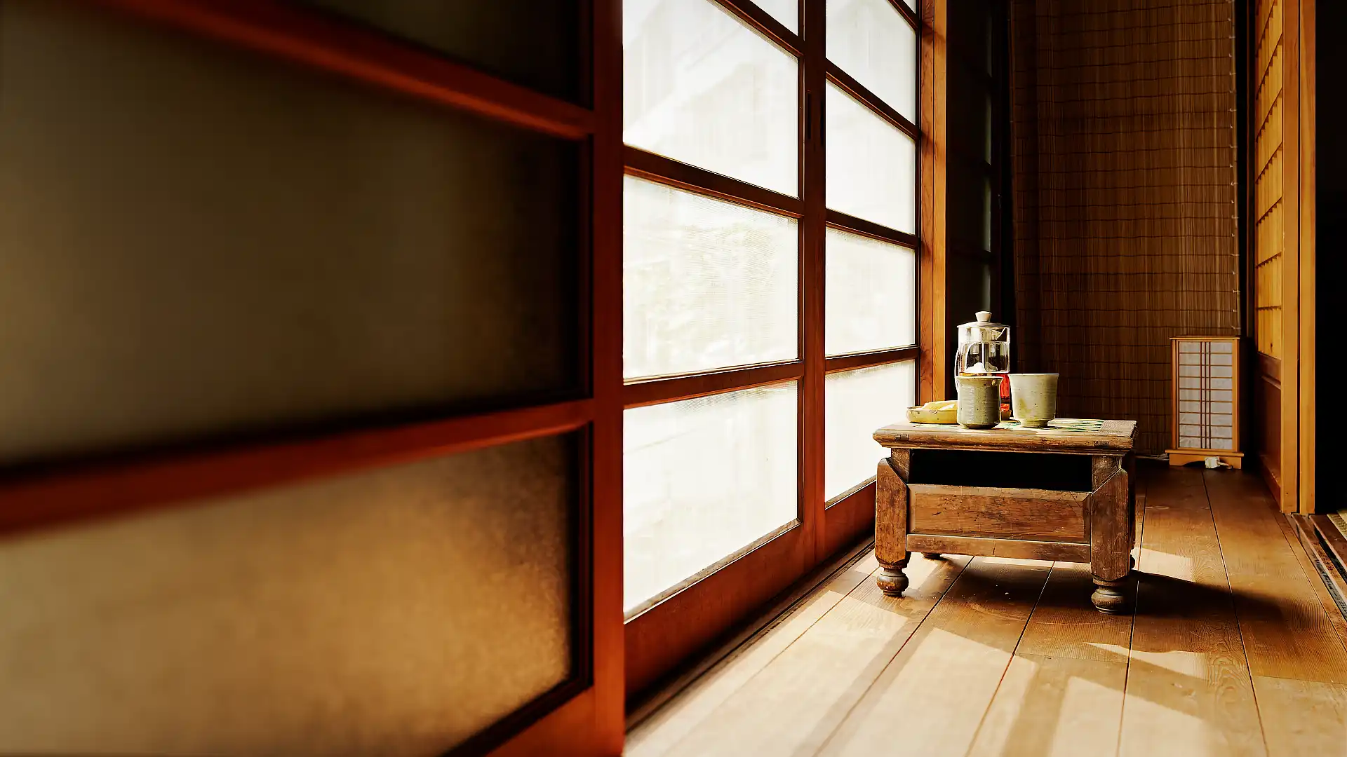 A short wooden table in an indoor–outdoor transition space at ‘A Book Wooden House’, Fangliao, Pingtung, Taiwan.