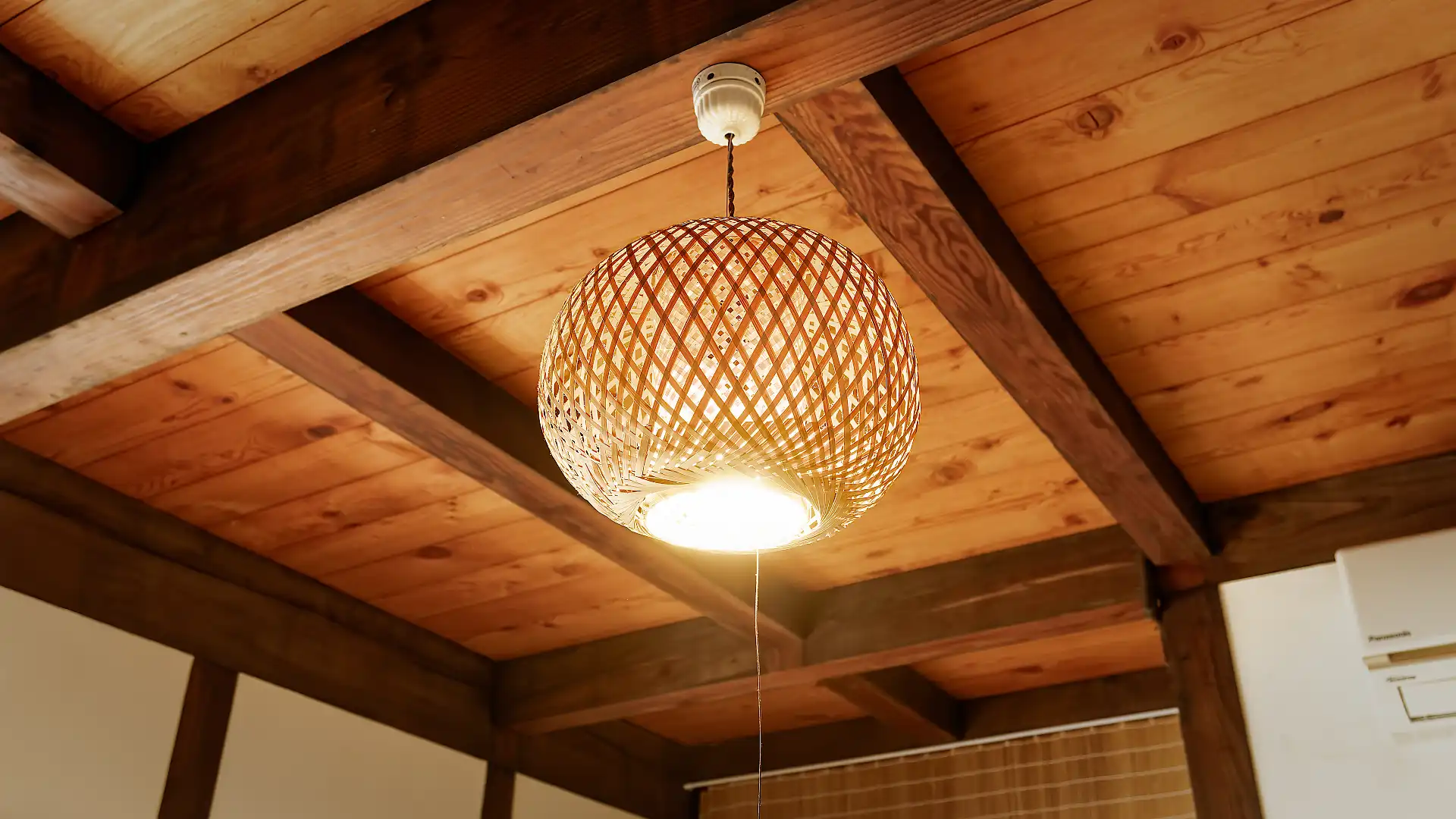 A spherical wooden lampshade hanging from the ceiling.