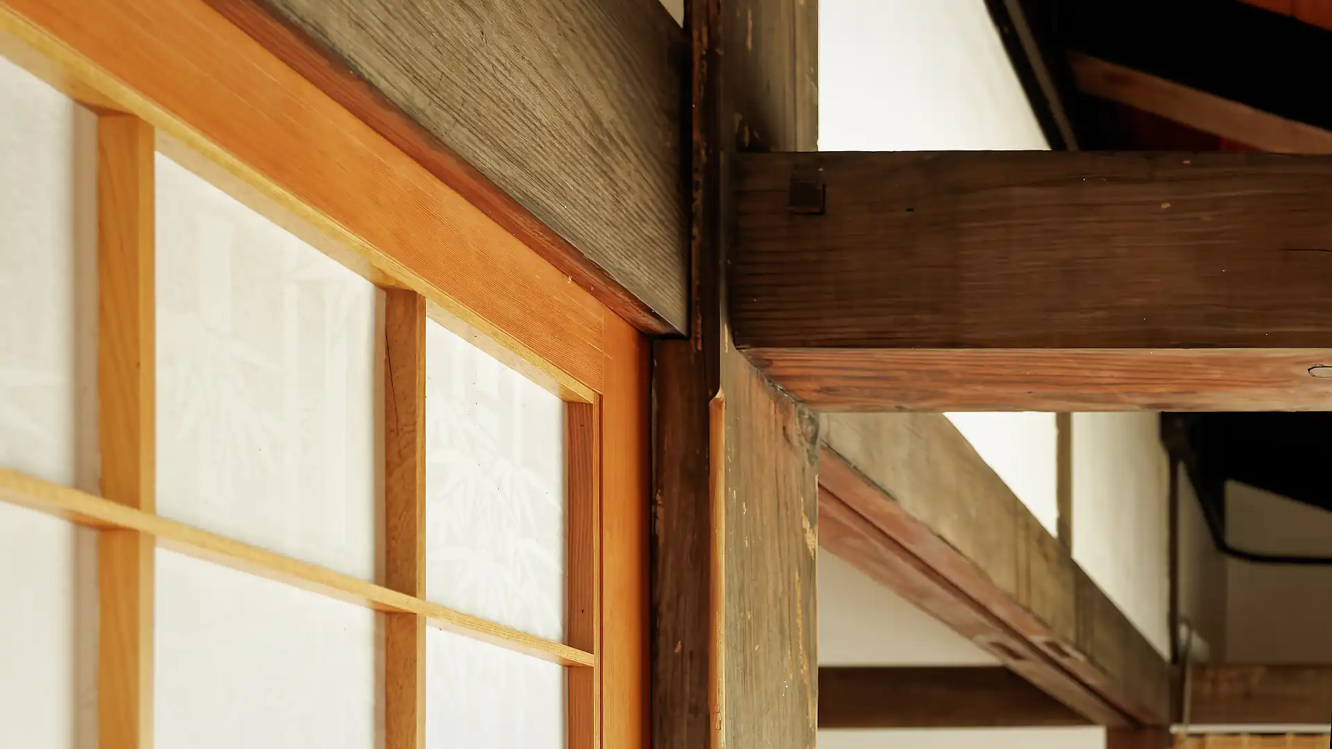Close-up of a shoji screen meeting wooden beams.