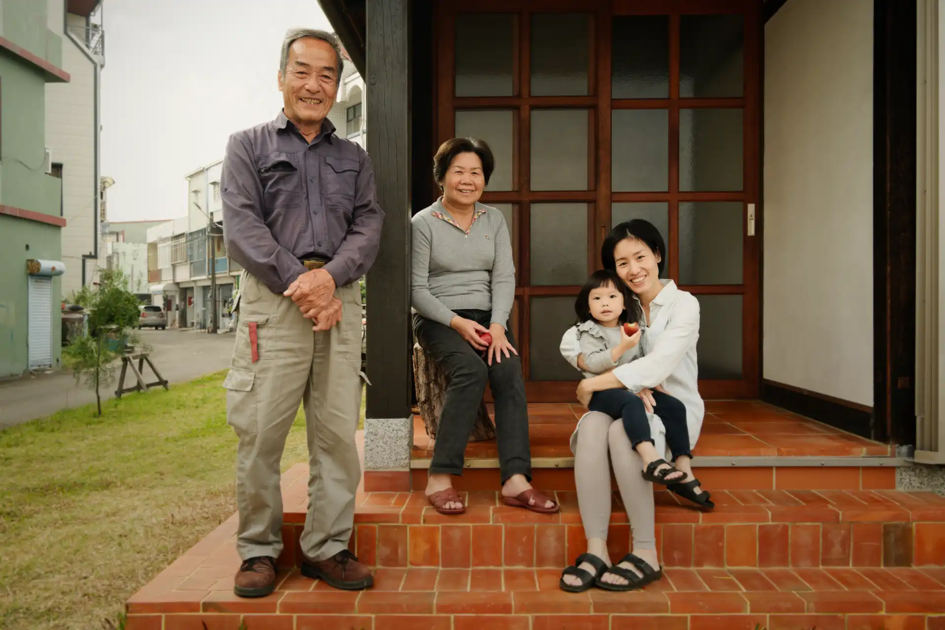 The Yang family on the steps of ‘A Book Wooden House’ in Fangliao Township, Pingtung, Taiwan.