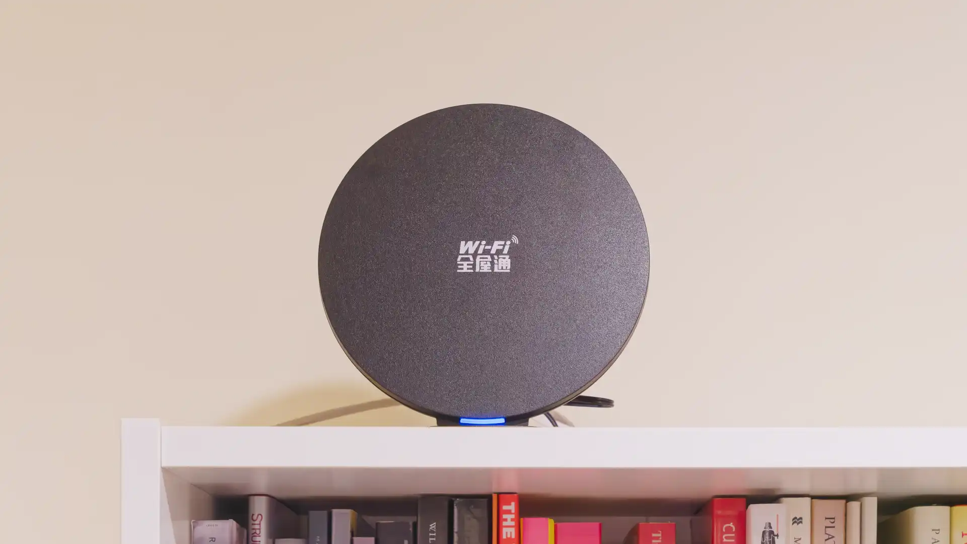 A circular Zyxel Wi-Fi modem perched on top of a bookcase. The modem’s blue power light is on.