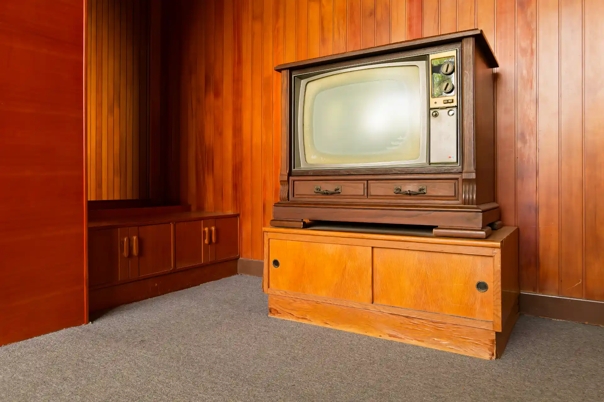 A vintage RCA television inside a wooden cabinet.