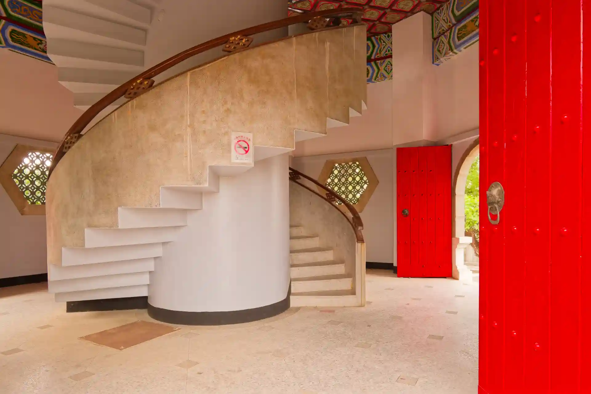 The ground floor of a Chinese Pagoda. It is immaculately clean, and features a double helix-style staircase leading to the upper floors.