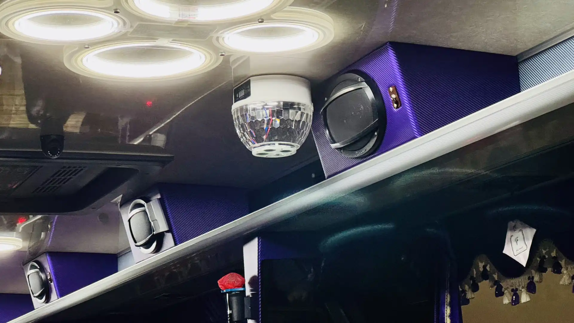 Bus interior close-up of a ceiling-mounted disco ball.